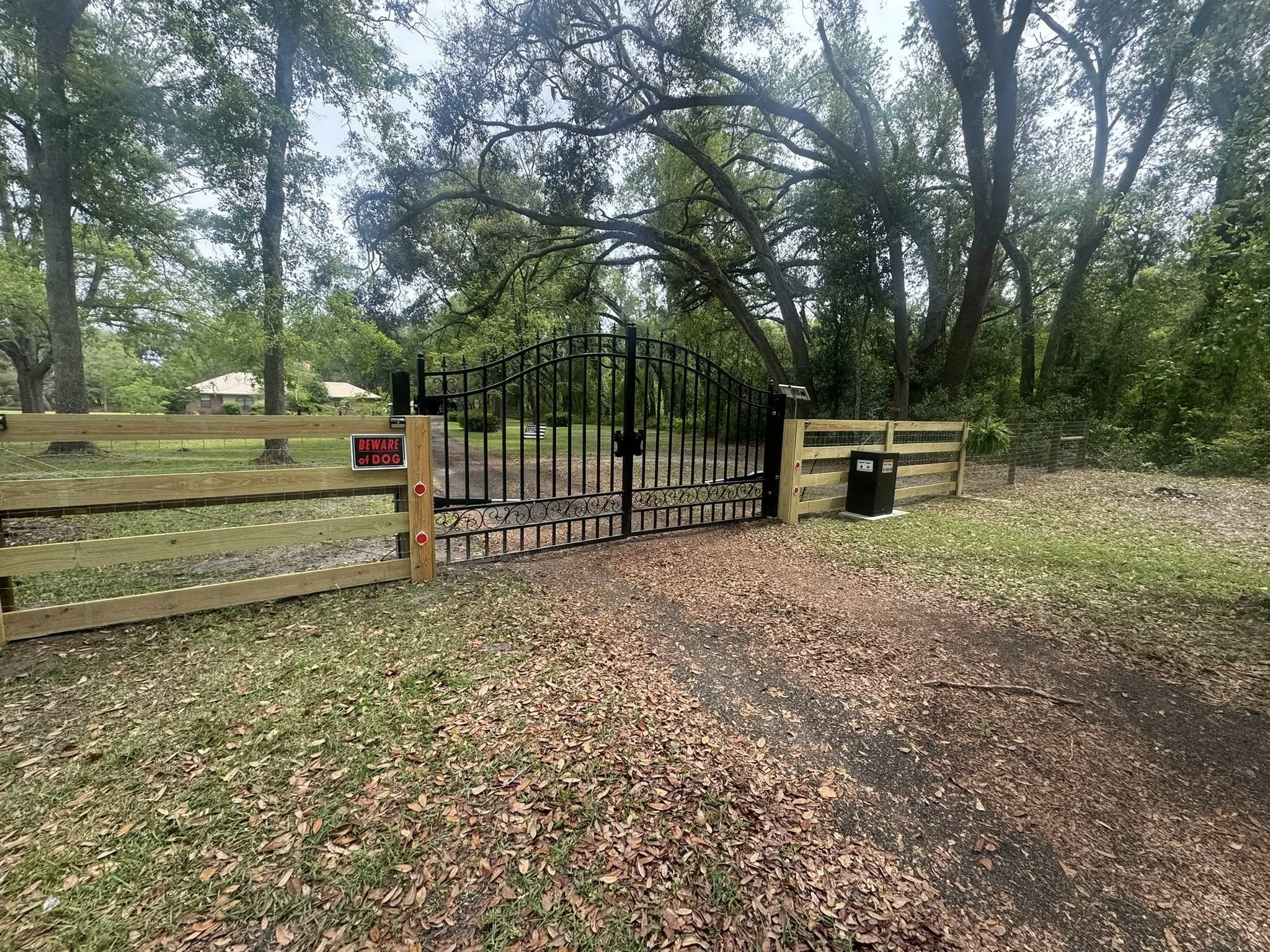 Custom ornamental driveway gate installed on a rural North Florida property