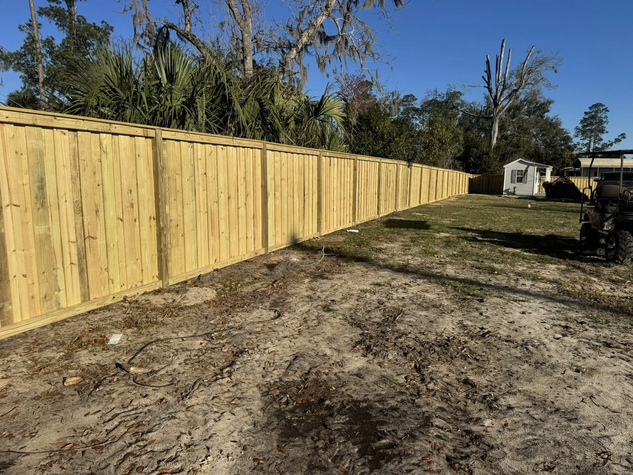 Custom wood fence design built by Poole Fencing